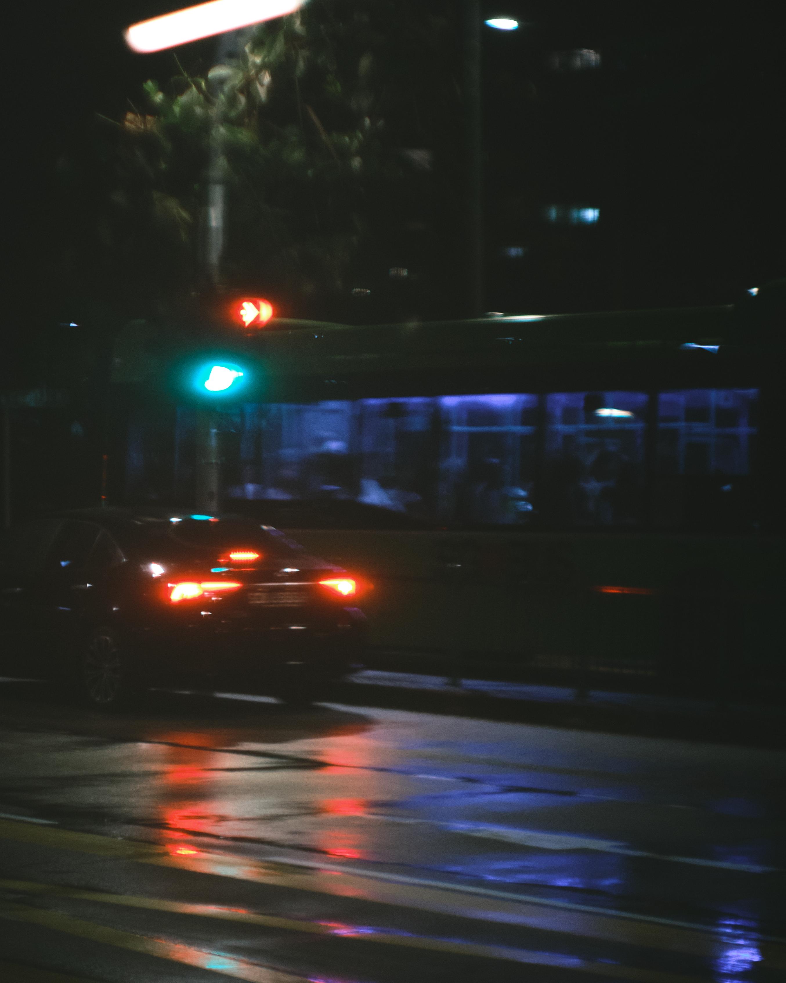 a bus and car at midnight